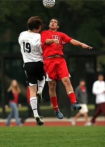 Two Soccer Players Jumping for the ball